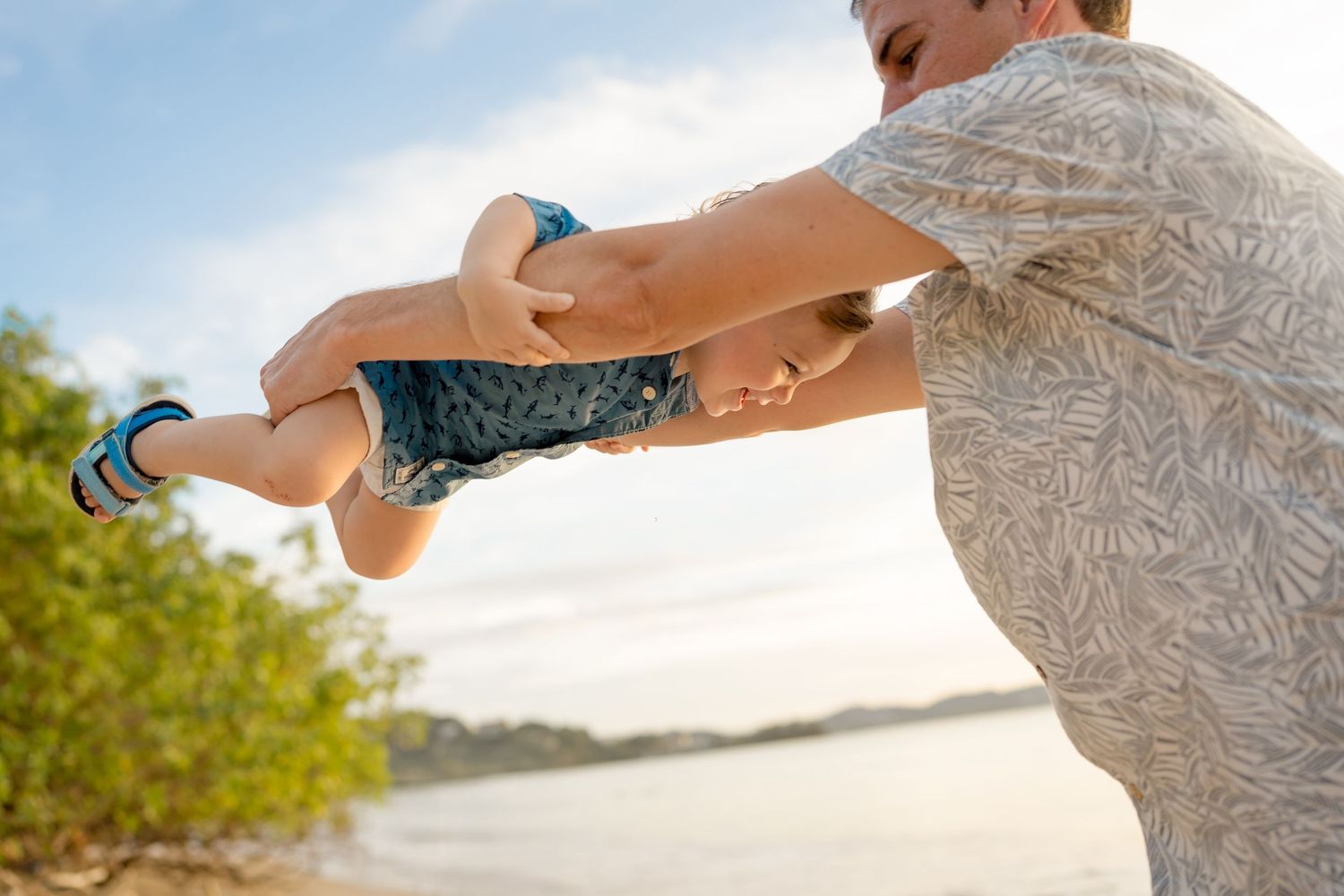 Father playing with his child during a relaxed family beach photography session in Costa Rica.