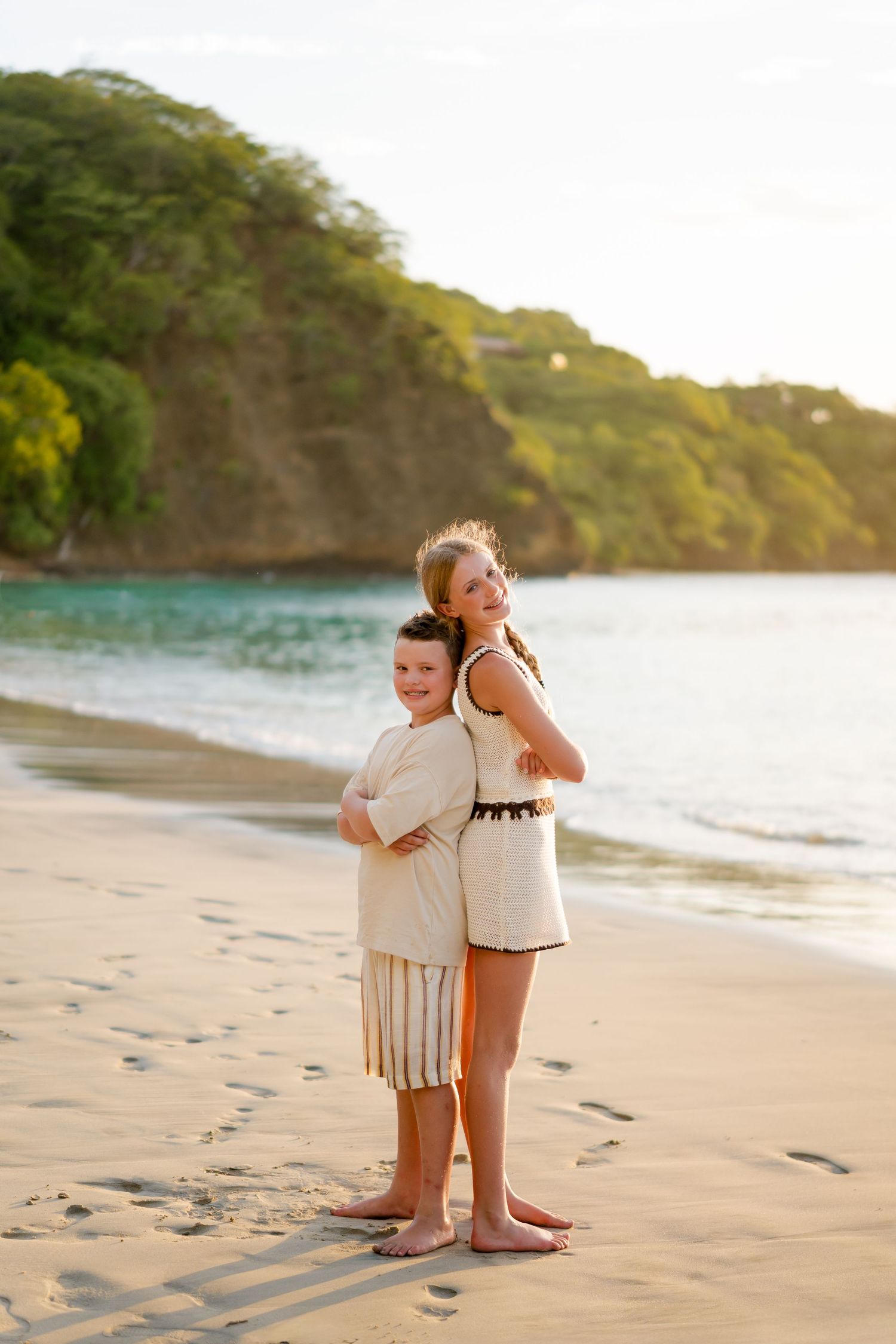 Siblings playing together on the beach during a family photography session in Peninsula Papagayo, Costa Rica.
