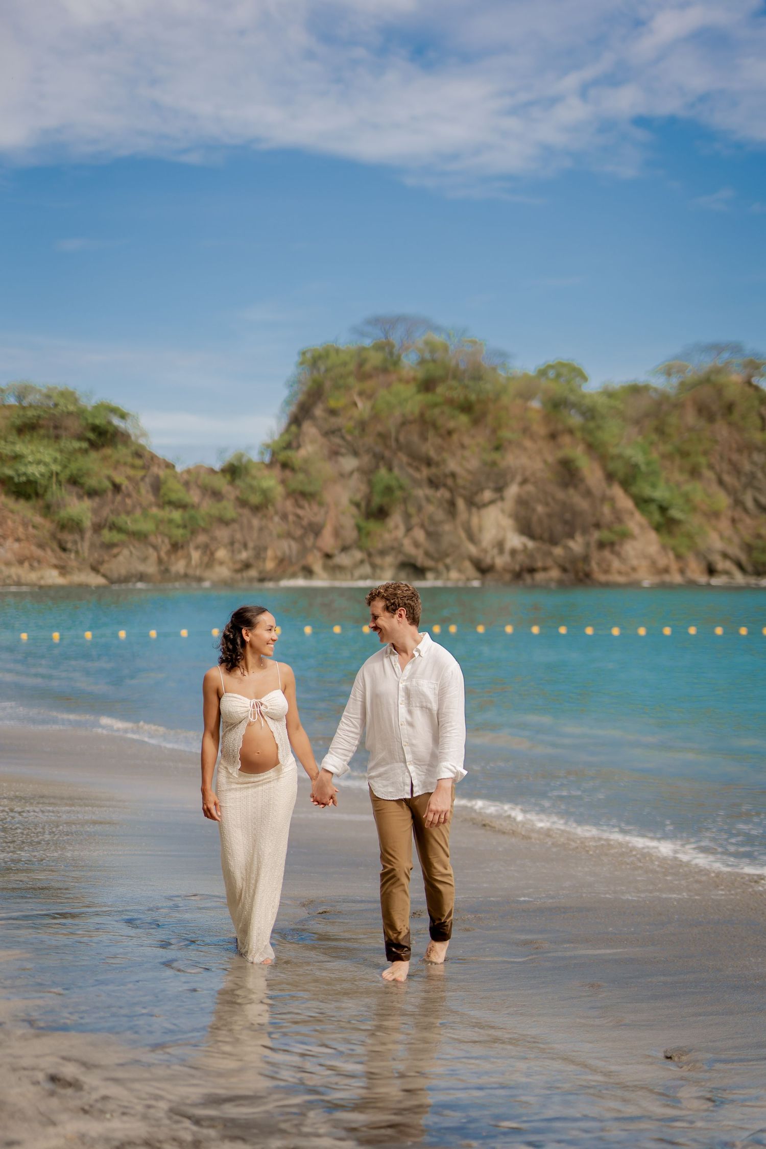 Couple walking along the beach during a photography session at Nekajui, a Ritz-Carlton Reserve in Peninsula Papagayo, Costa Rica.