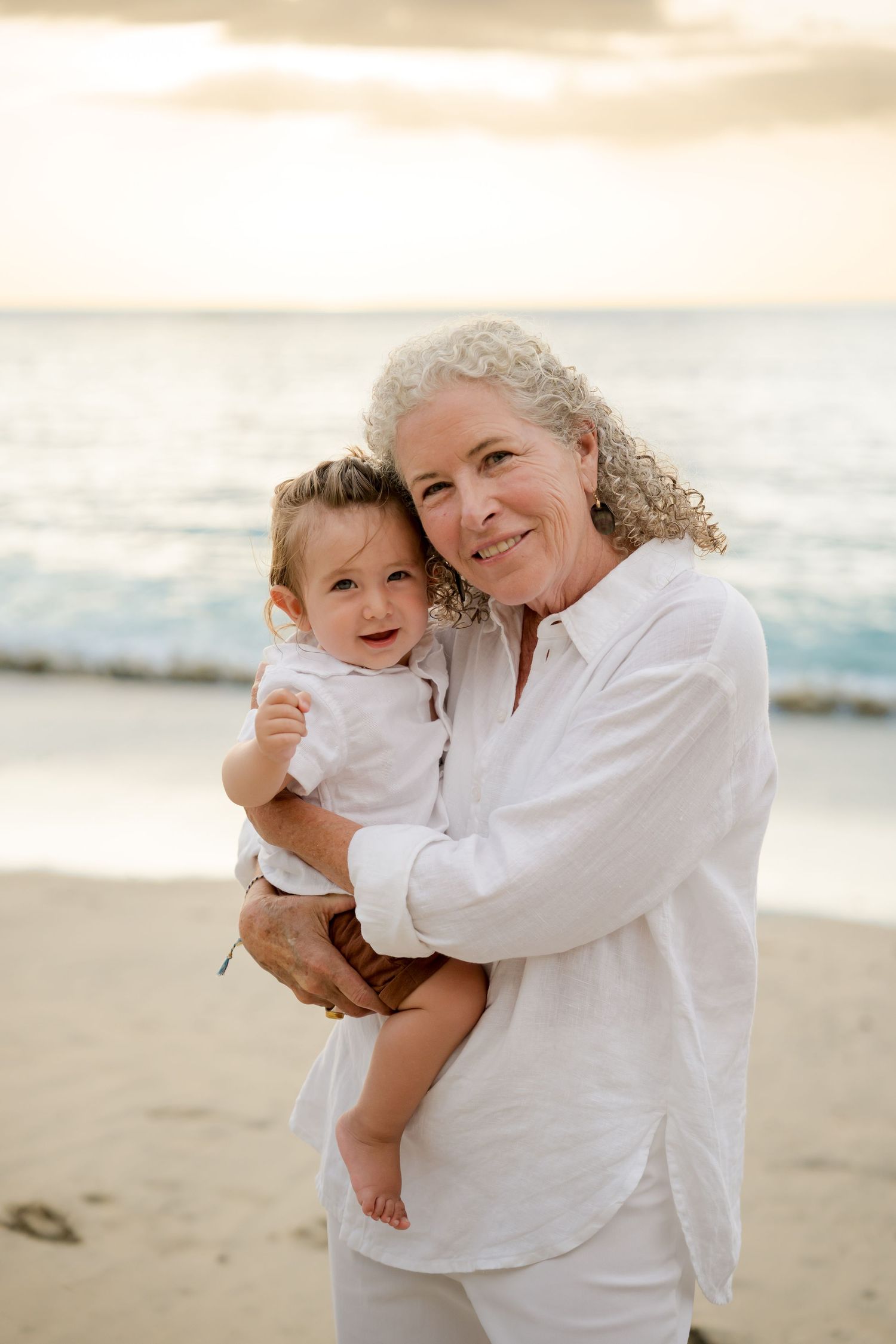 Grandmother holding her grandchild during a family beach photography session in Peninsula Papagayo, Costa Rica.