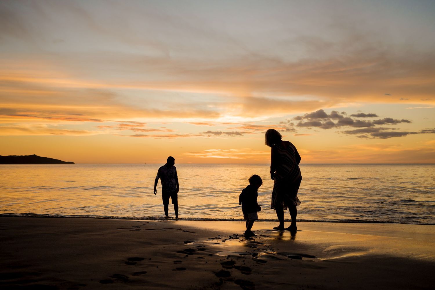 Family playing along the beach at sunset during a vacation photography session at Nekajui, a Ritz-Carlton Reserve in Costa Rica