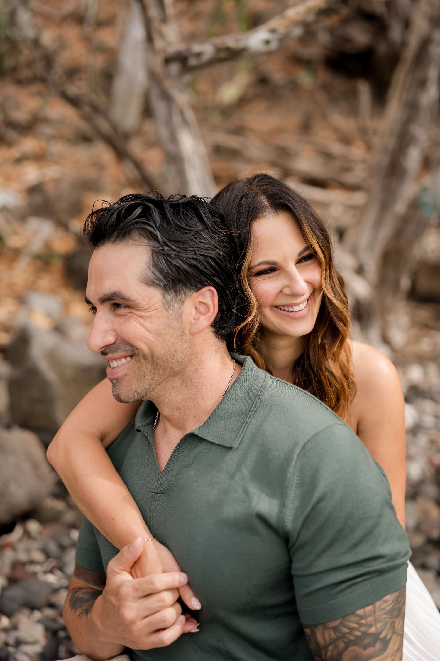 Couple laughing and embracing during a natural romantic photography session at Andaz Peninsula Papagayo, Costa Rica.