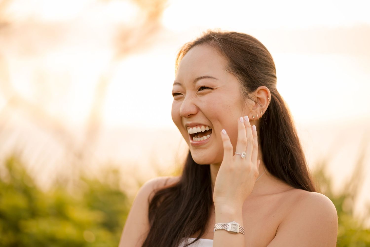Woman smiling and showing her engagement ring during a Costa Rica proposal photography session.