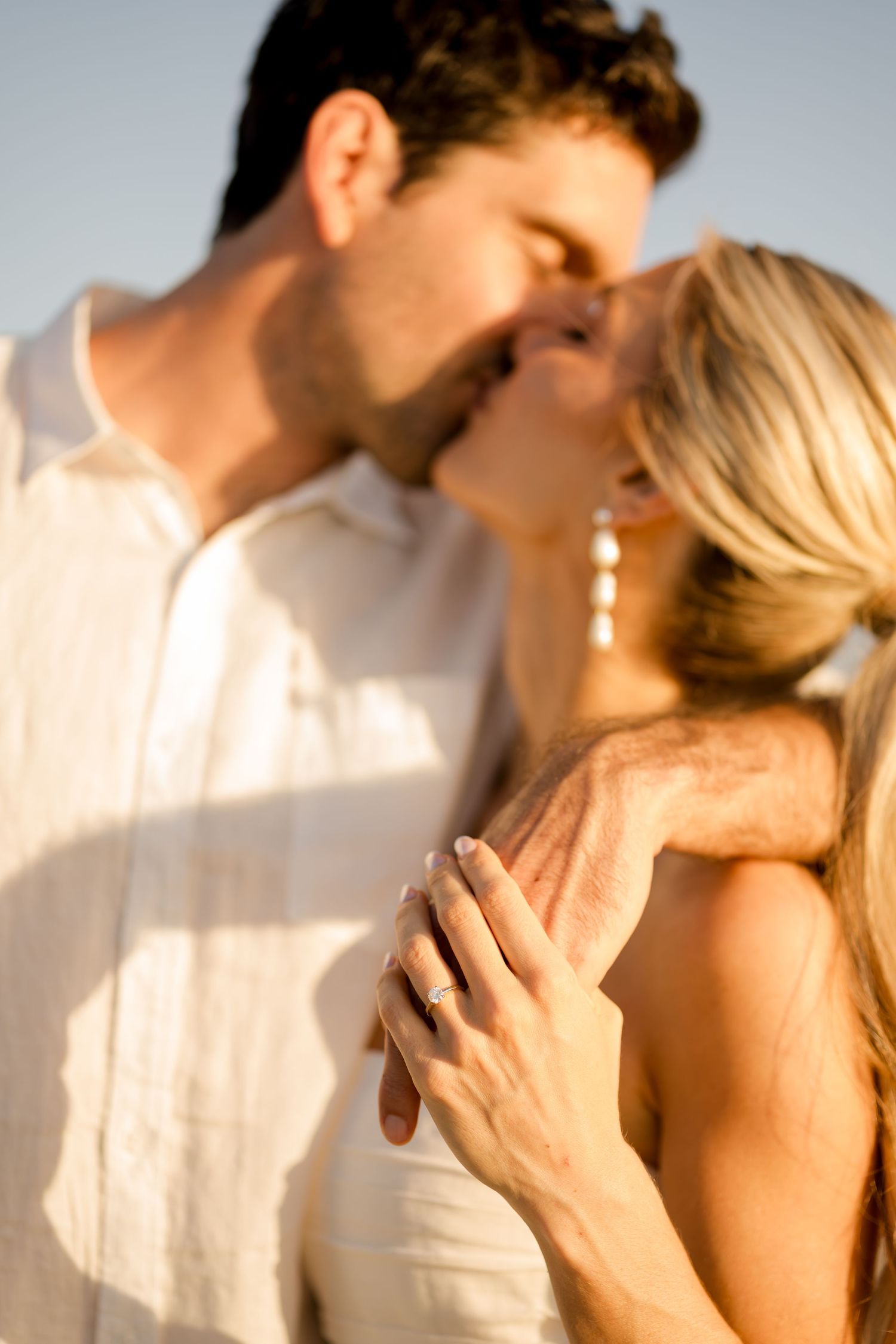 Couple sharing a romantic moment during a beach photography session at Hacienda Pinilla, Costa Rica.