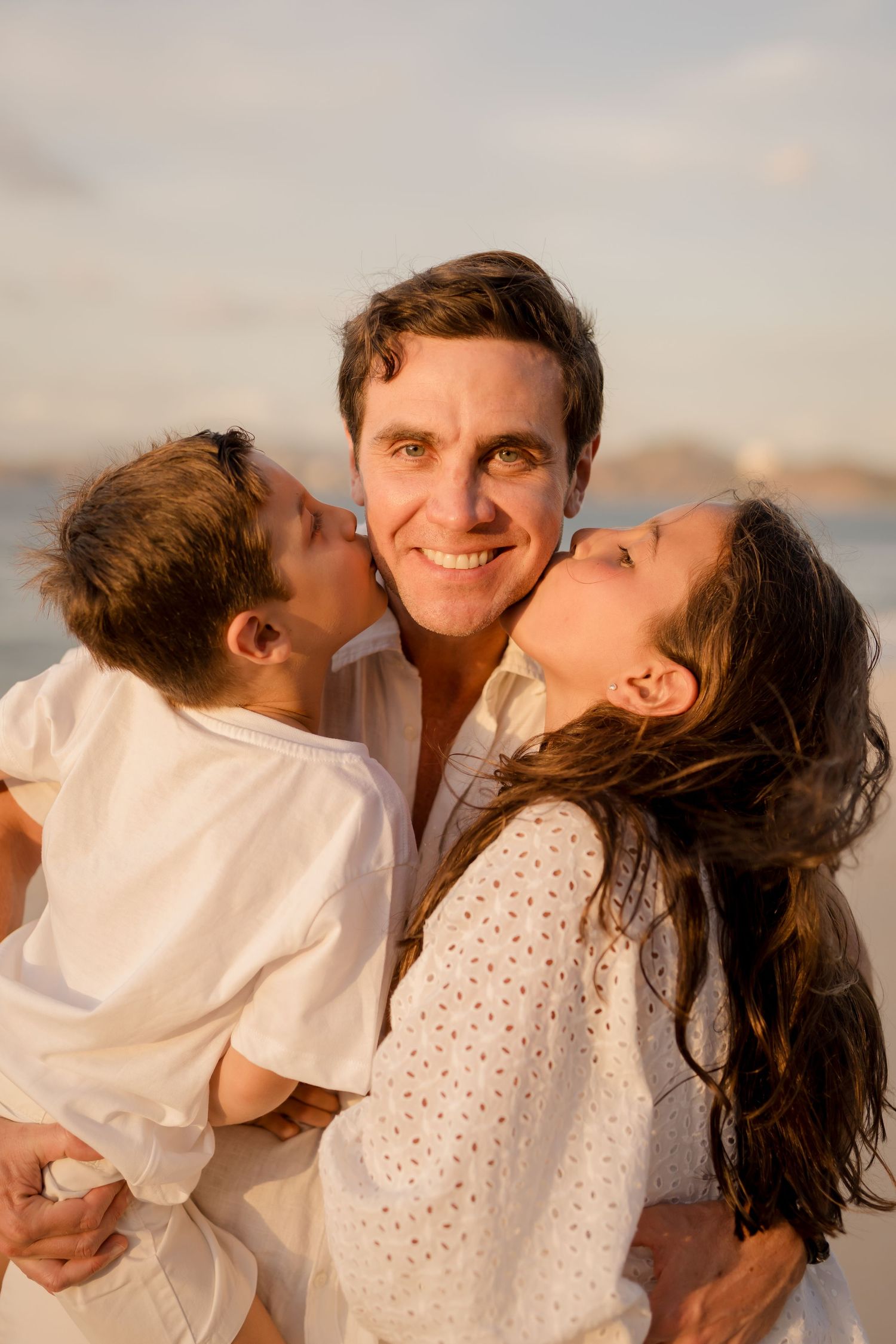 Natural family portrait of parents and their children during golden hour at Playa Conchal, Costa Rica.