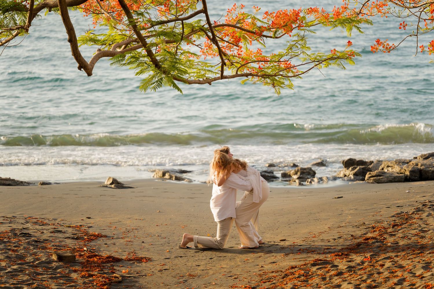 Couple embracing after a romantic beach proposal at Playa Ocotal in Guanacaste, Costa Rica.