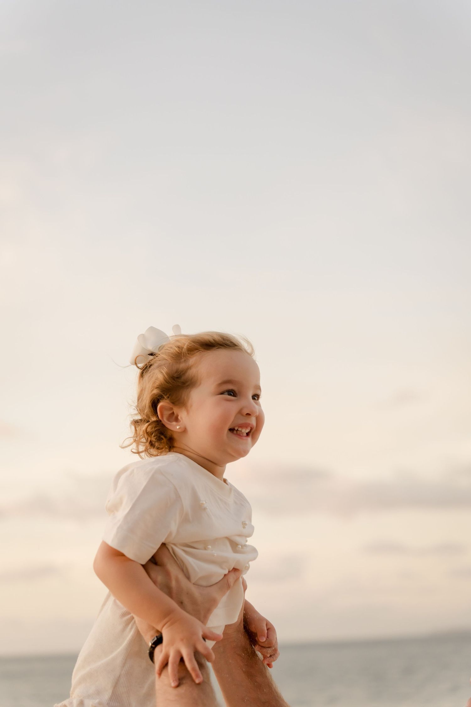 Young child enjoying the beach during a family vacation photography session at Playa Conchal, Costa Rica.