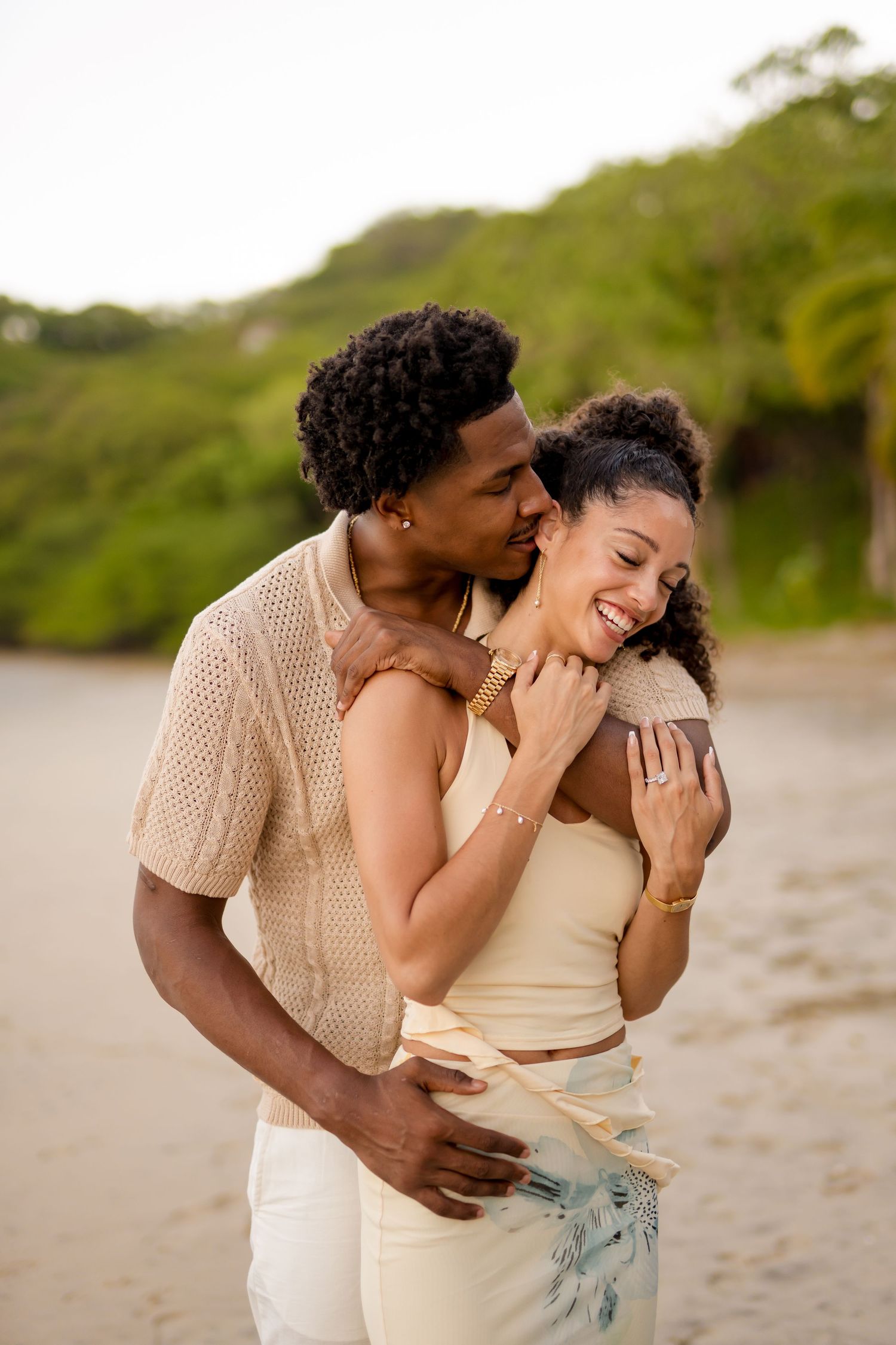Couple embracing and laughing during a romantic beach photography session at Four Seasons Resort Peninsula Papagayo, Costa Rica.