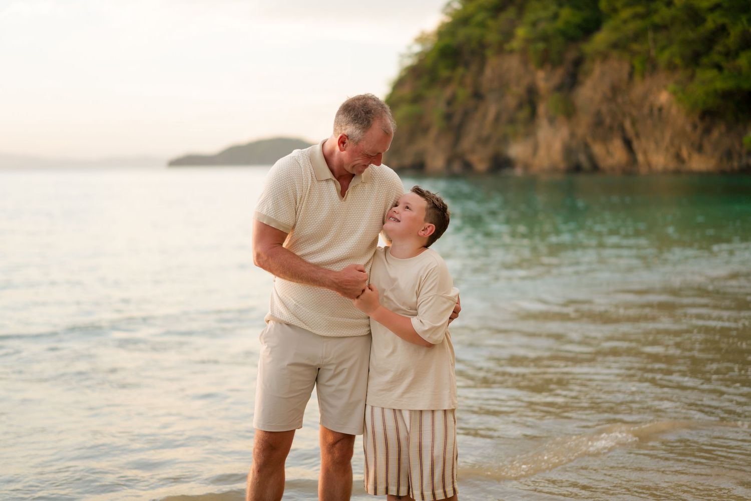 Father and son sharing a playful moment on the beach during a family photography session in Peninsula Papagayo, Costa Rica.