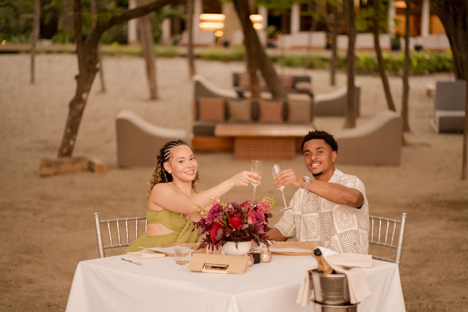 Newly engaged couple celebrating with a romantic beach dinner at Andaz Peninsula Papagayo in Costa Rica.