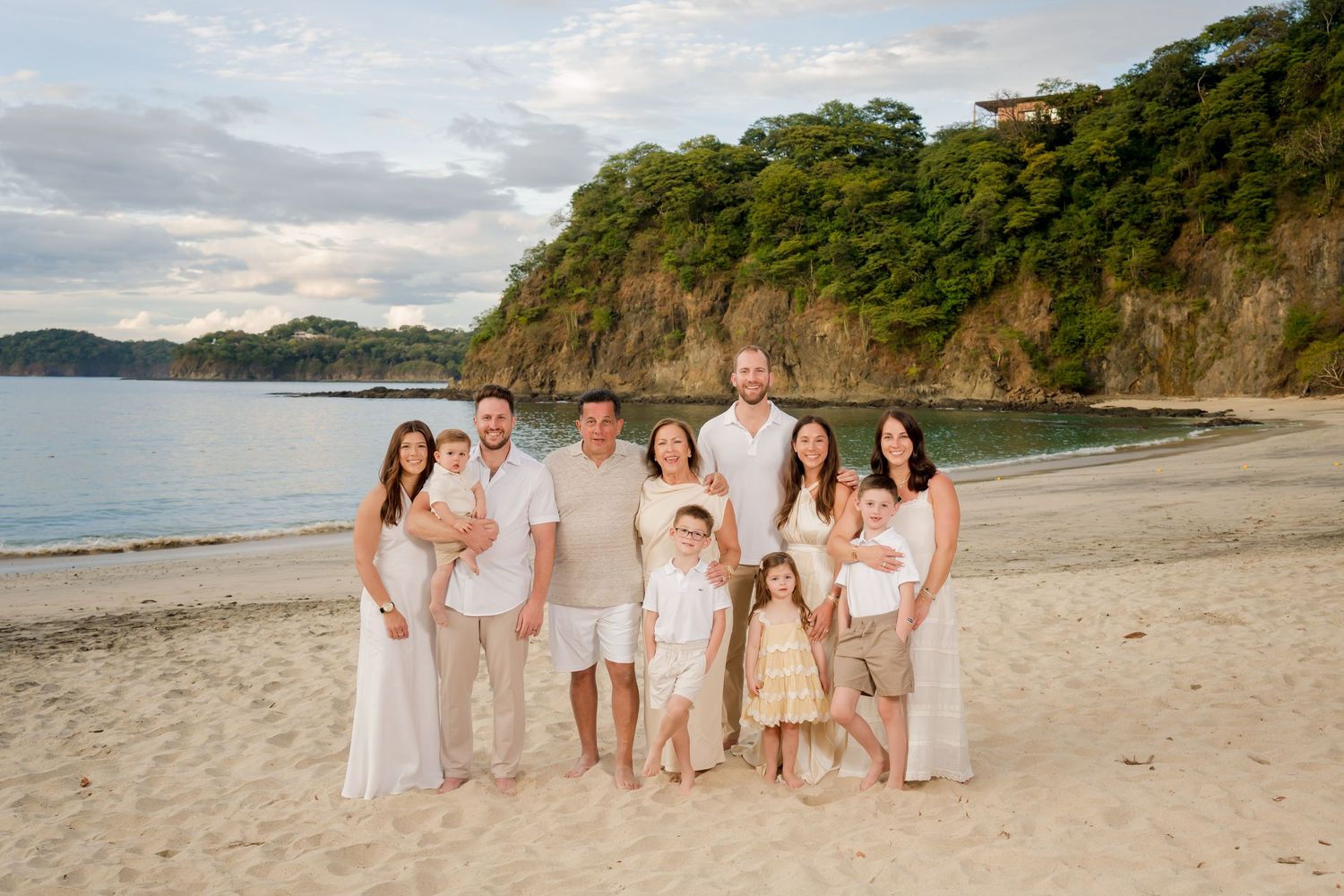 Multi-generational family gathered together on the beach during a family photography session in Costa Rica.