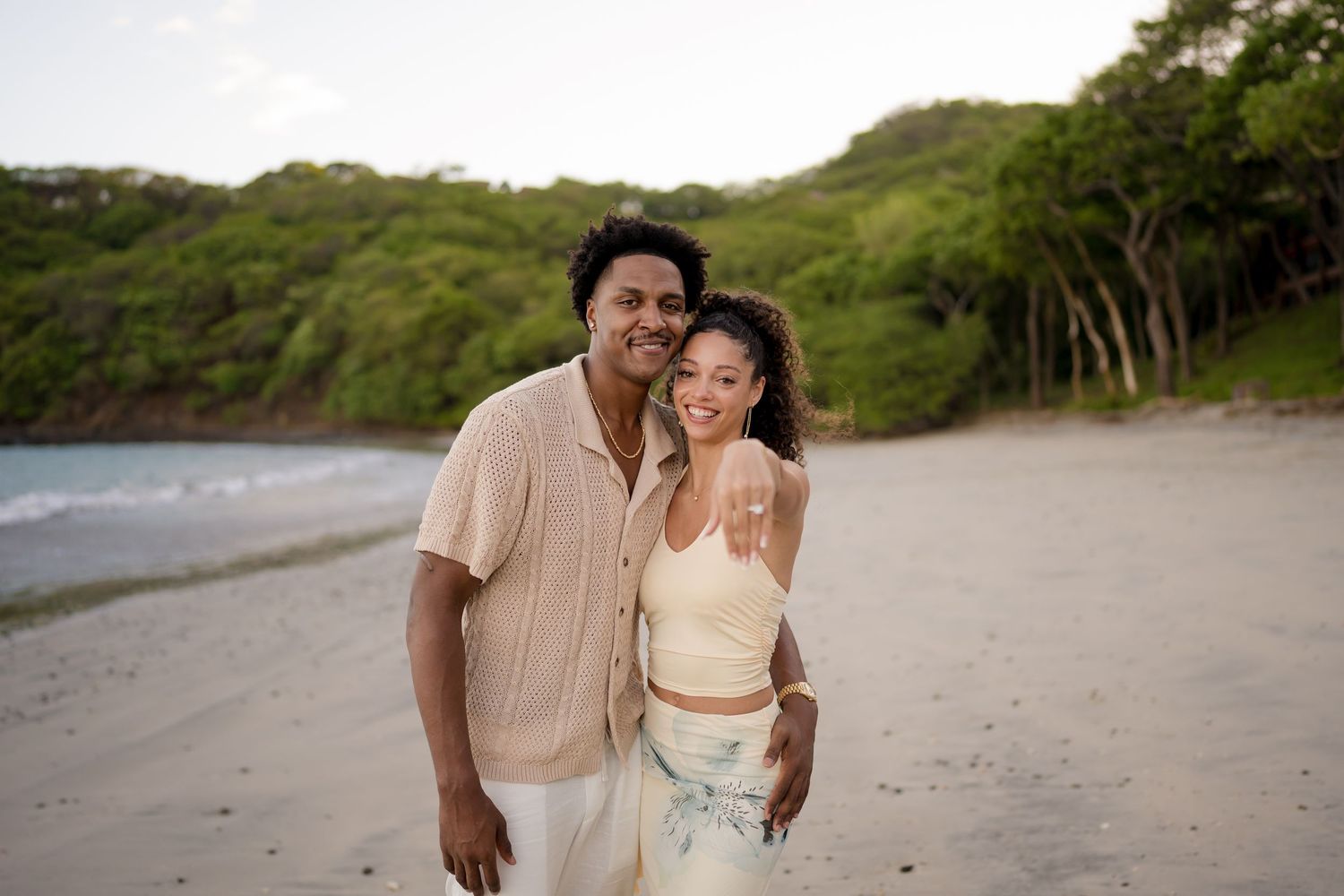 Couple laughing together on the beach during a romantic photography session in Peninsula Papagayo, Costa Rica.