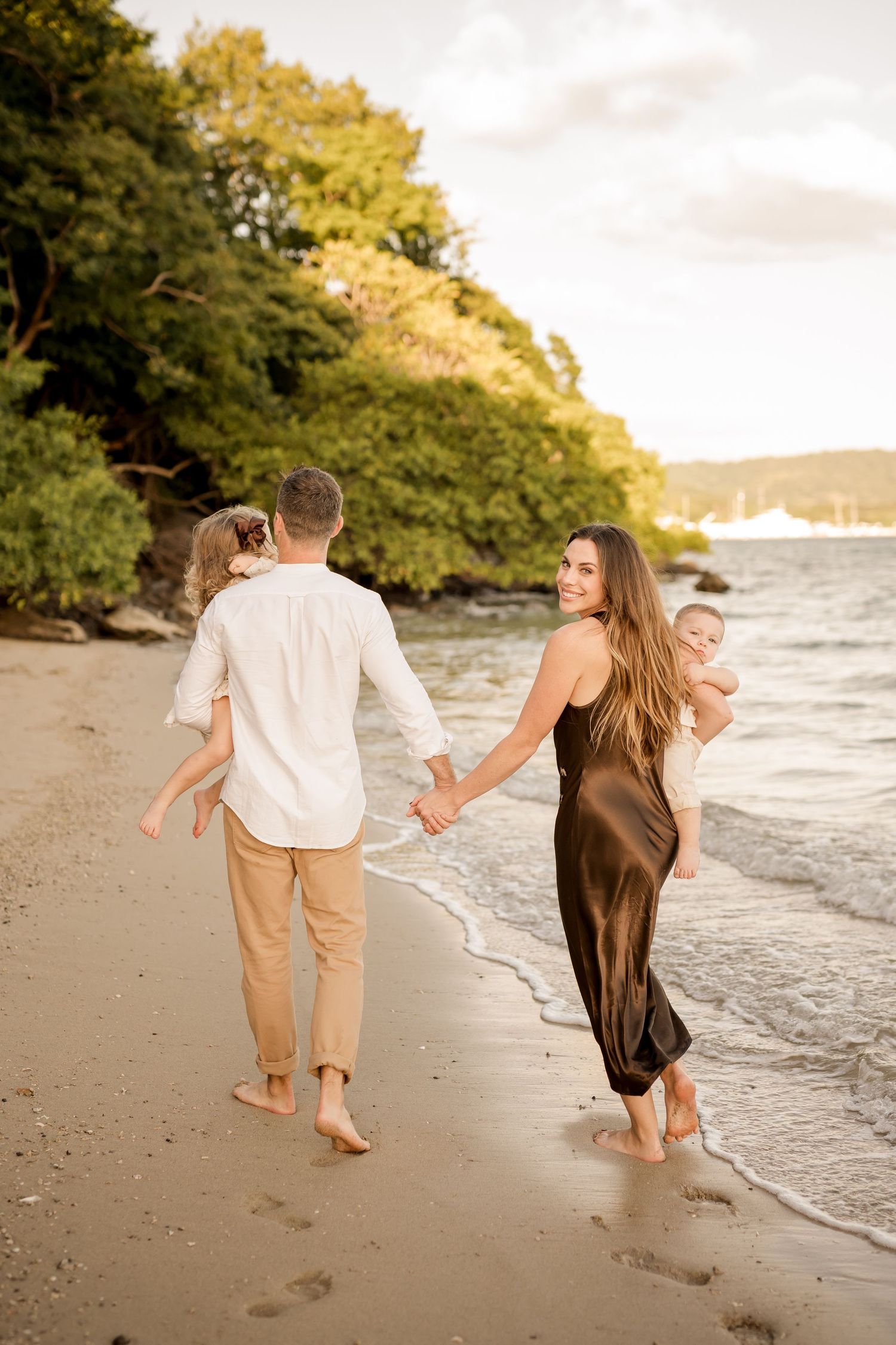 Couple walking hand in hand along the beach during a relaxed photography session at Andaz Peninsula Papagayo, Costa Rica.