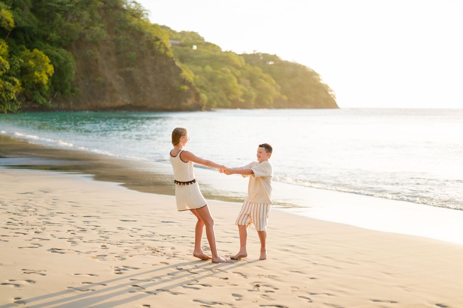 Siblings playing together on the beach during a family photography session at Four Seasons Costa Rica at Peninsula Papagayo.