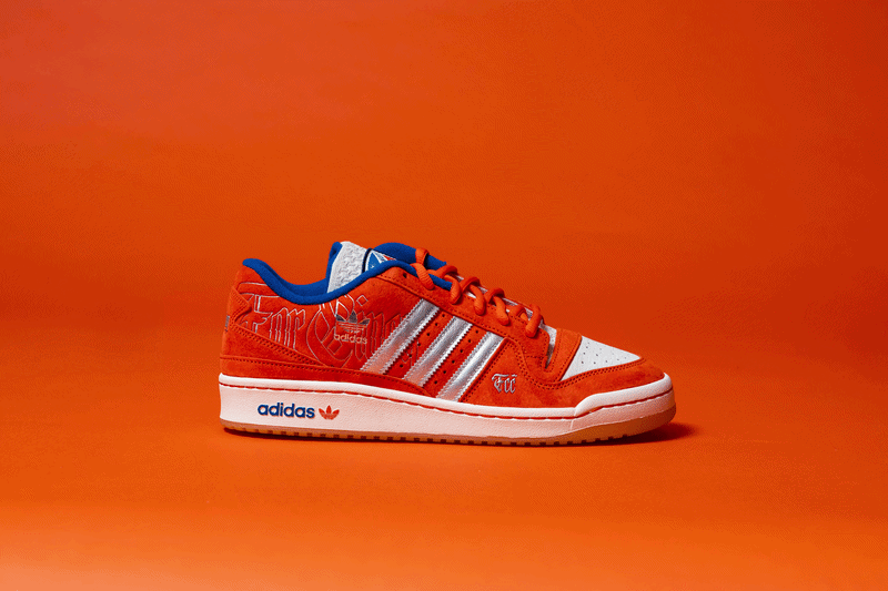 Animated view of an orange Adidas sneaker rotating to showcase multiple angles, including the side profile, sole, and upper details.