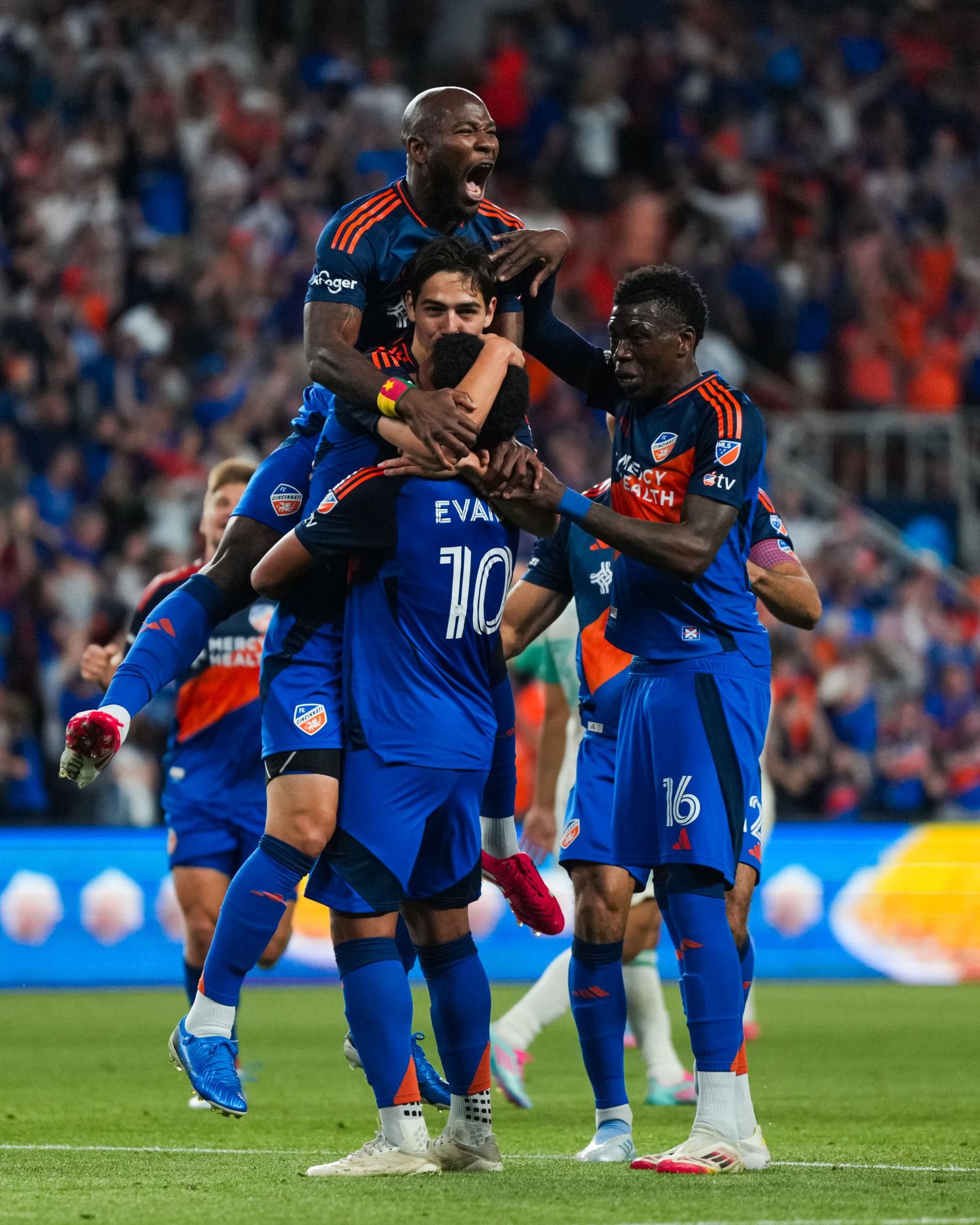 FC Cincinnati players celebrate together on the field following a scoring play during a match.