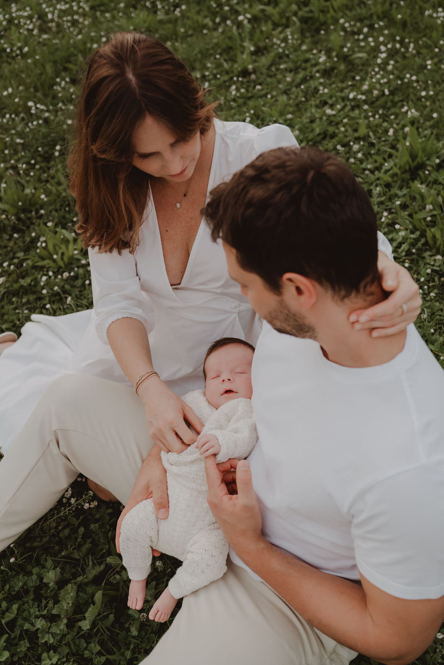Couple enjoying a family photo session with their young baby.