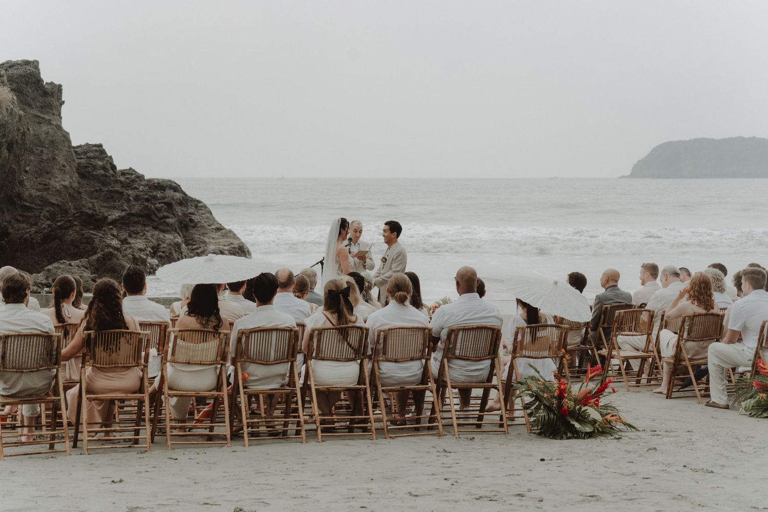Bride and groom during their beach wedding ceremony with their witnesses.