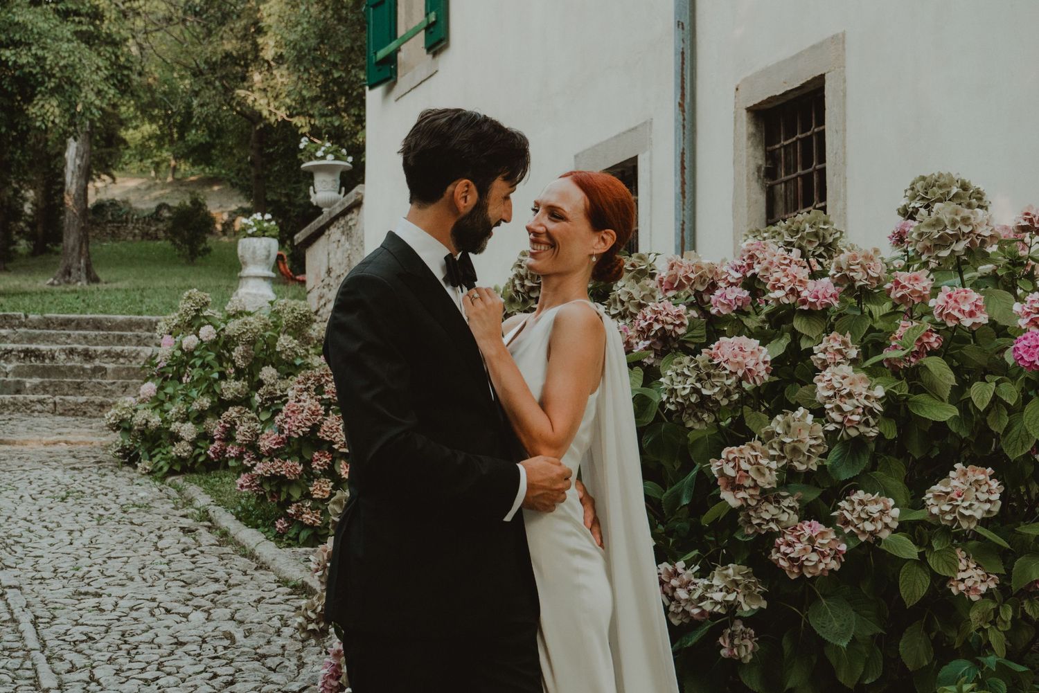 Wedding couple standing together at a historic villa in Verona, Italy.