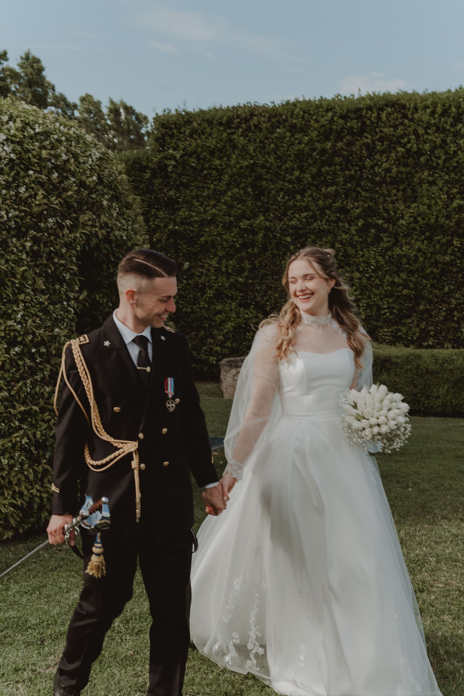 Bride and groom getting married in a castle, with the groom in his ceremonial uniform and the bride looking like a princess.