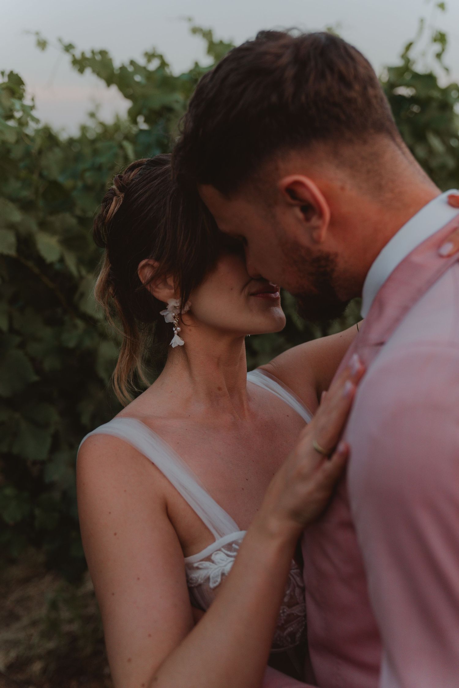 International newlywed couple sharing an intimate moment just before their first kiss.