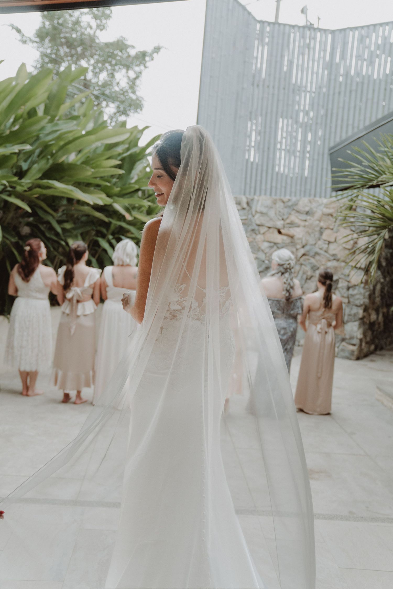 Bride's bridesmaids seeing her for the first time on her wedding day.