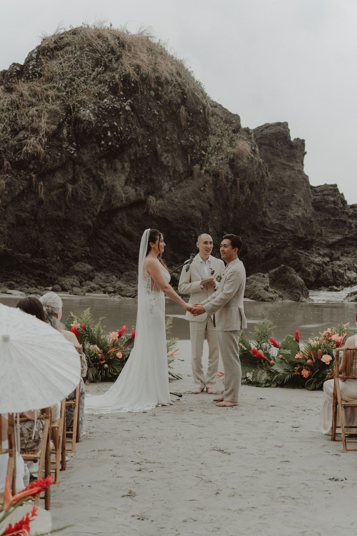 Bride and groom during their beach wedding ceremony with their witnesses.