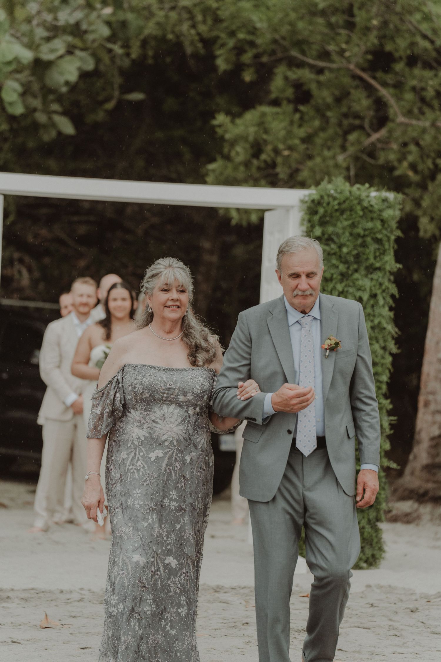 Bride's parents walking toward the wedding ceremony.