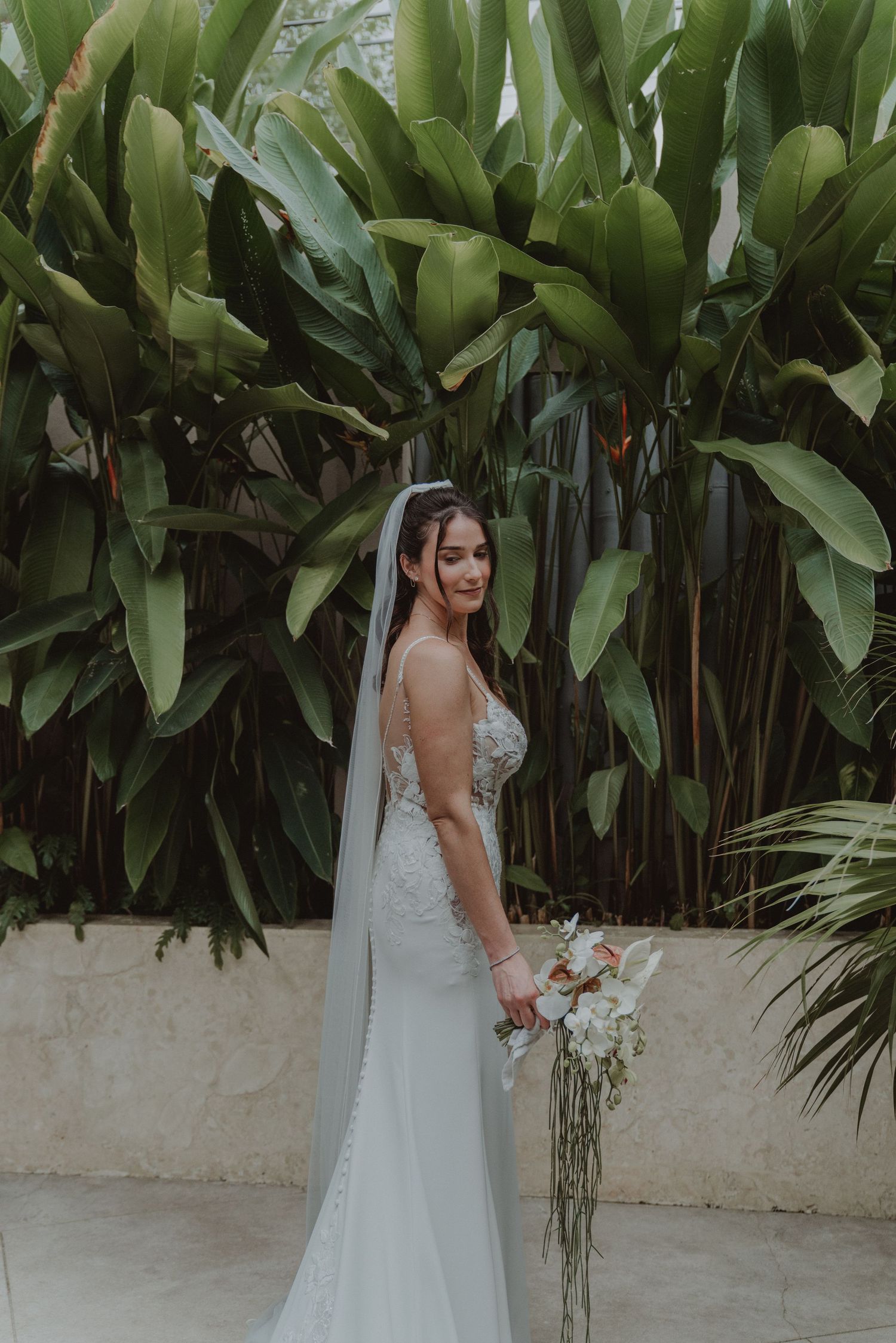 Bride wearing her wedding dress and holding her bridal bouquet.