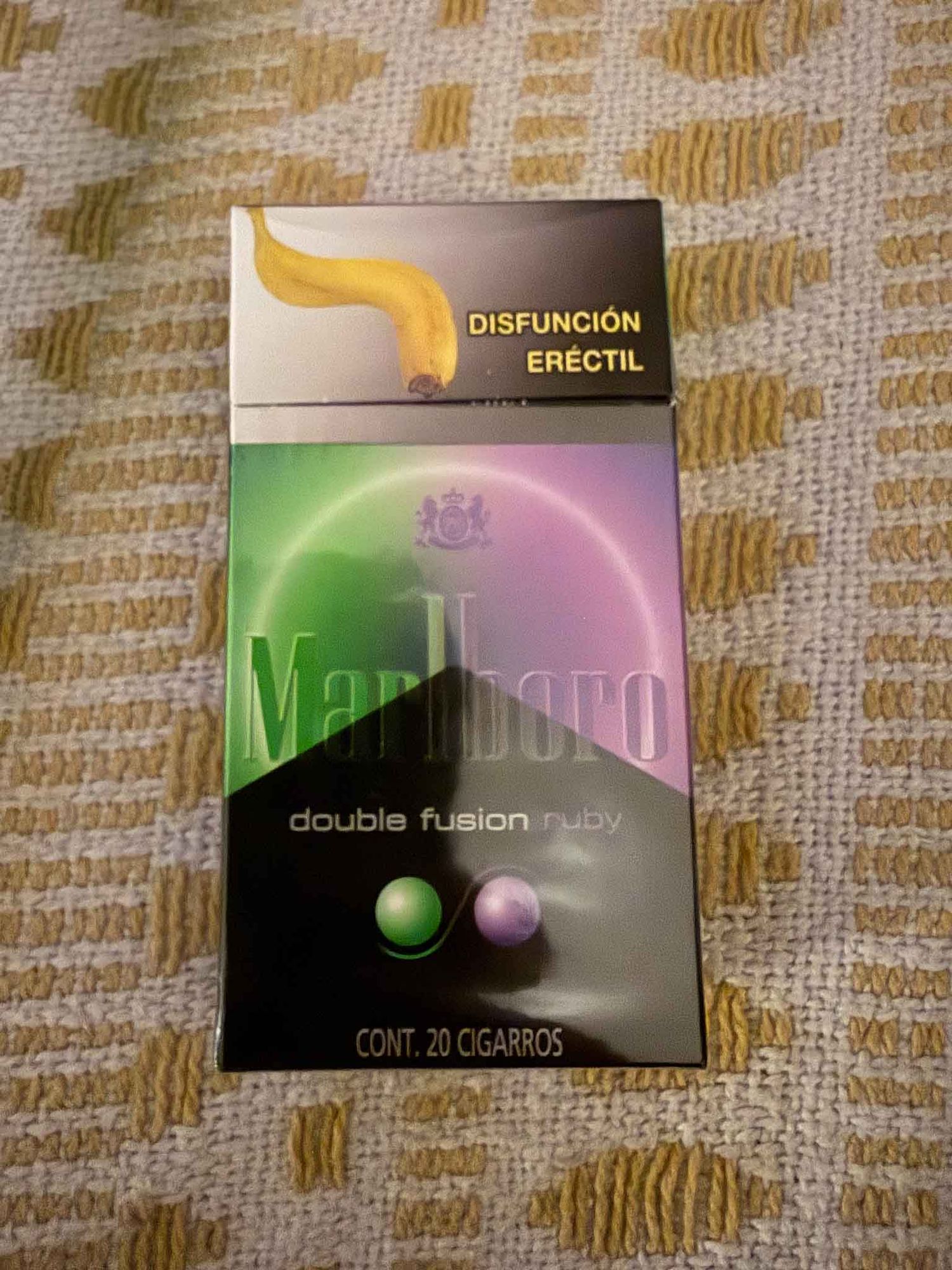 A pack of Marlboro Double Fusion Ruby cigarettes with a warning label about erectile dysfunction on the top.
