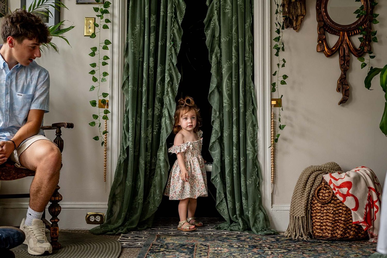 A sequence of playful interactions photographed against green curtains and indoor plants.