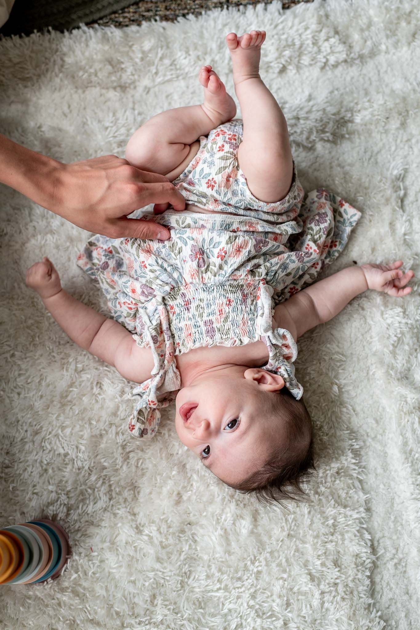 A series of candid shots showing playful moments on a plush white carpet.