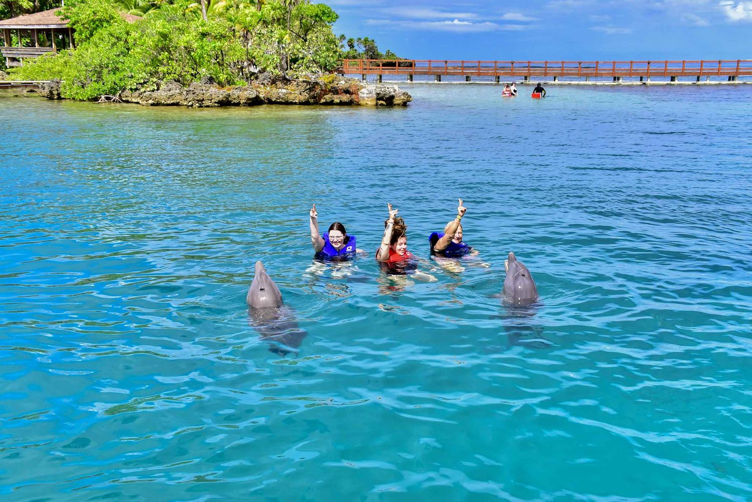 Swimmers enjoy the crystal clear turquoise waters of a tropical lagoon on a sunny winter day.
