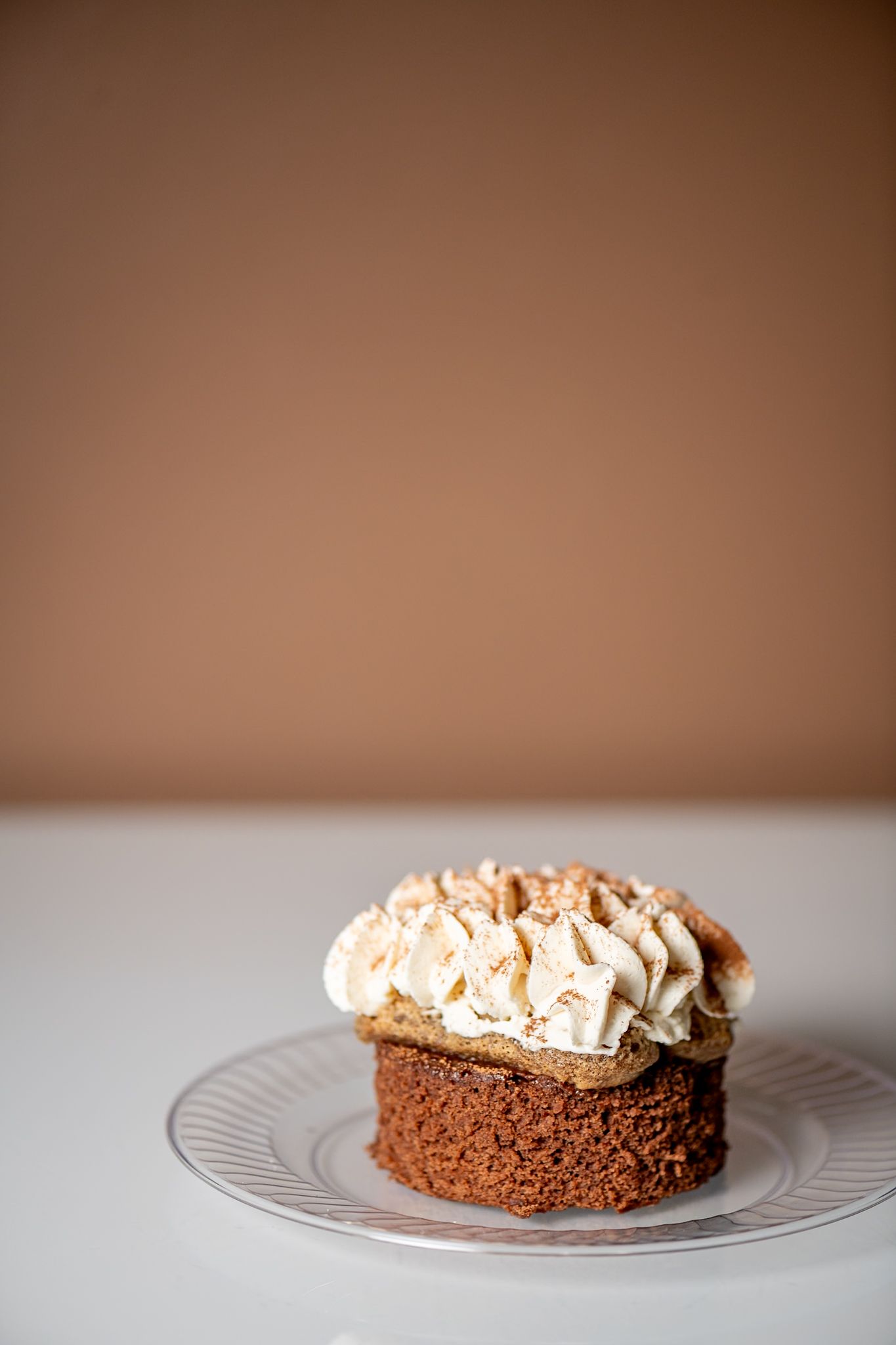 Chocolate pie with whipped cream topping served on an elegant white plate.