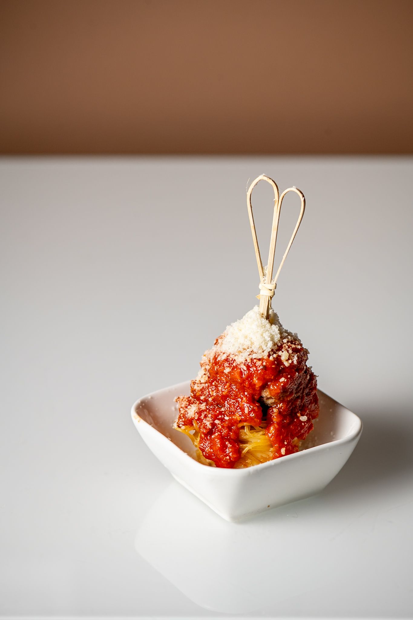 Bright red caviar appetizer presented in a modern white dish with garnish.