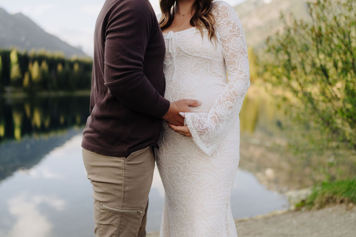 Romantic moment captured against a backdrop of mountains and a tranquil lake.