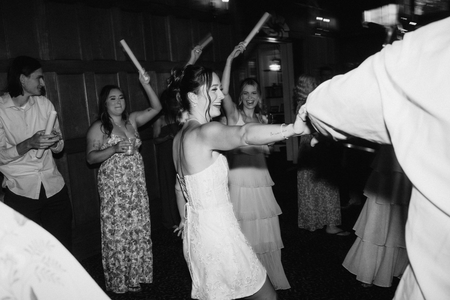 Black and white photo of wedding reception dance floor celebrations.