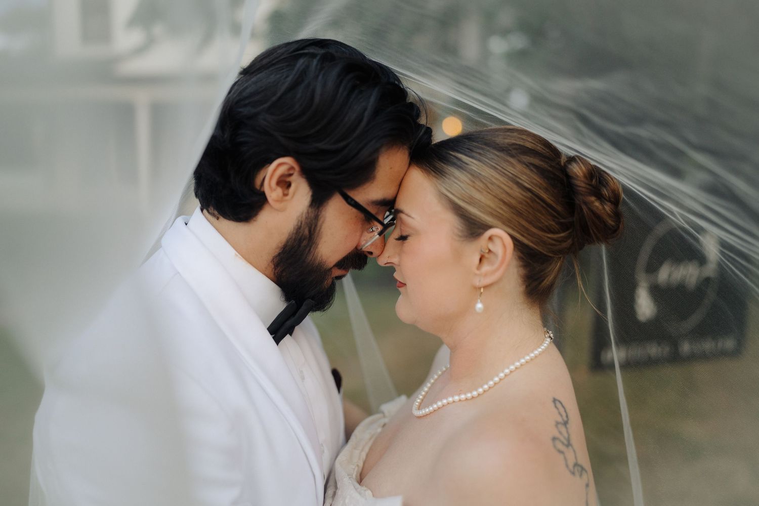 Intimate wedding portraits captured against a soft, dreamy background.
