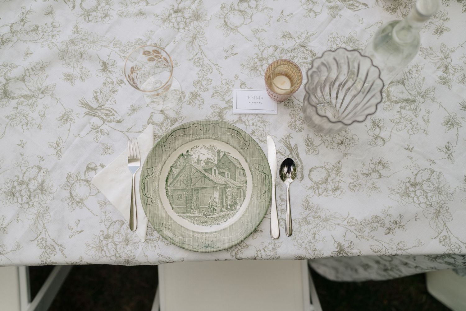 Elegant table settings with floral patterned linens and vintage-inspired place settings.