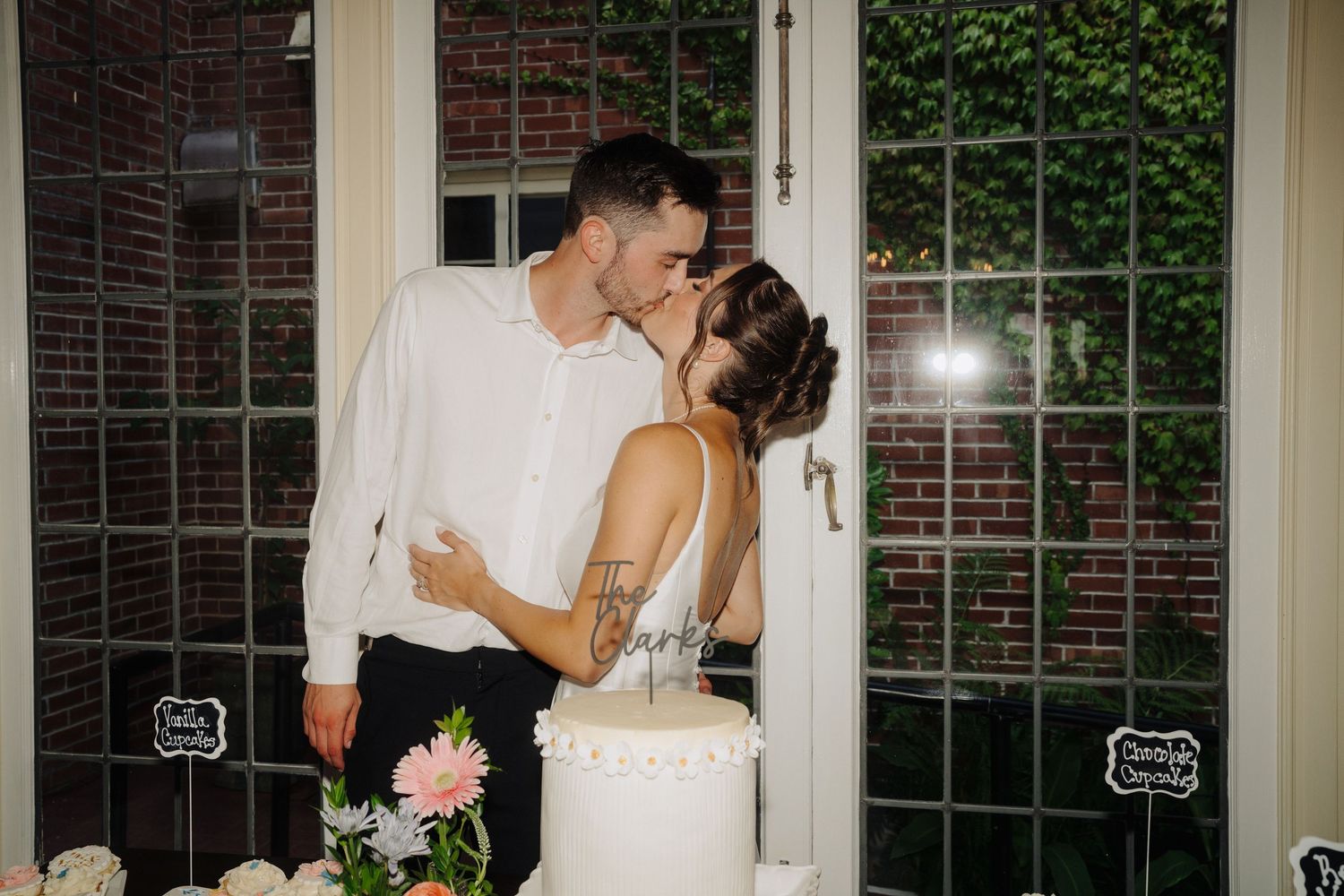 Romantic dance sequence by window with brick and ivy exterior.