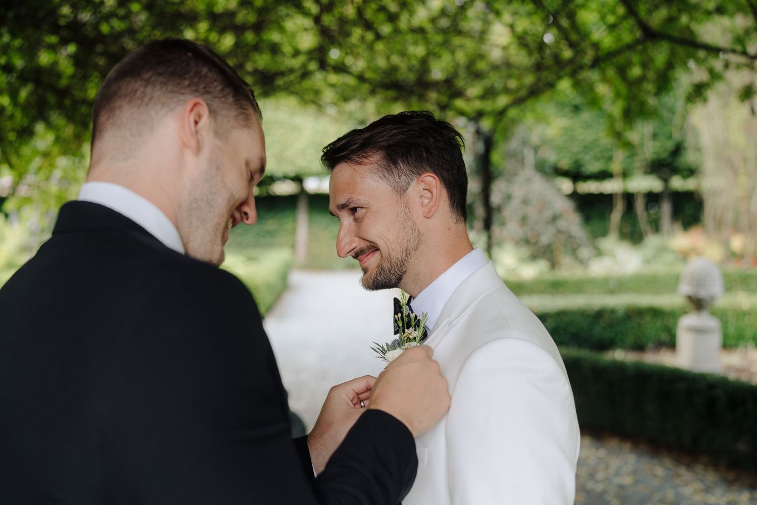 A romantic outdoor wedding scene with couples and guests sharing intimate moments in a garden setting.