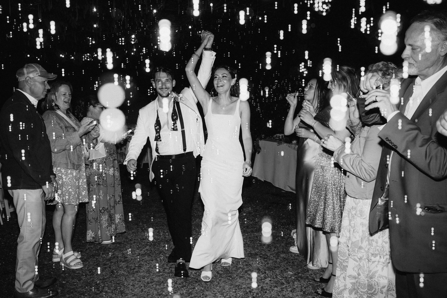 Wedding celebration at night with glowing lanterns creating a magical atmosphere.