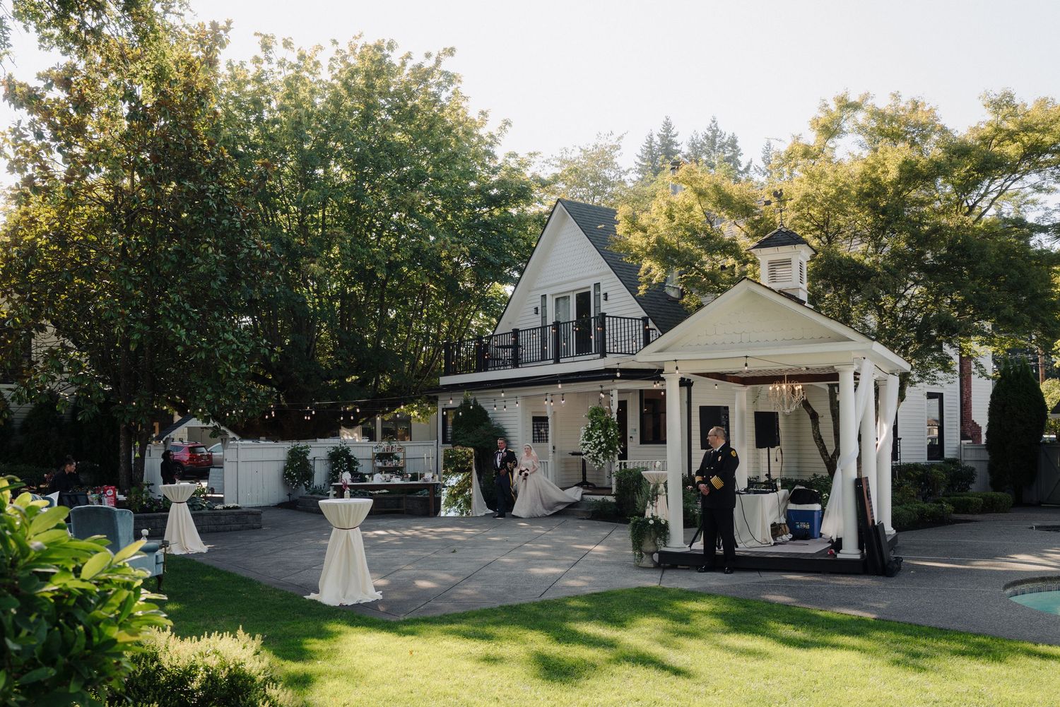 A charming wedding venue exterior with white buildings and landscaped grounds.