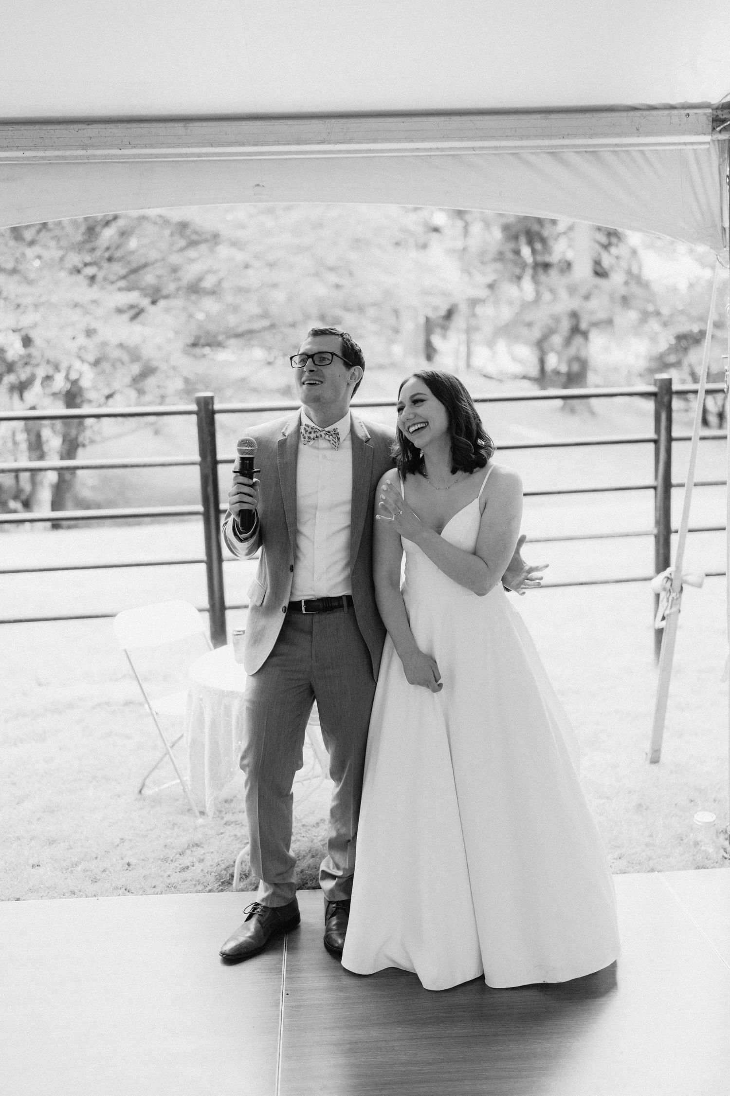 Black and white wedding photography on an outdoor deck with mountain views in the background.