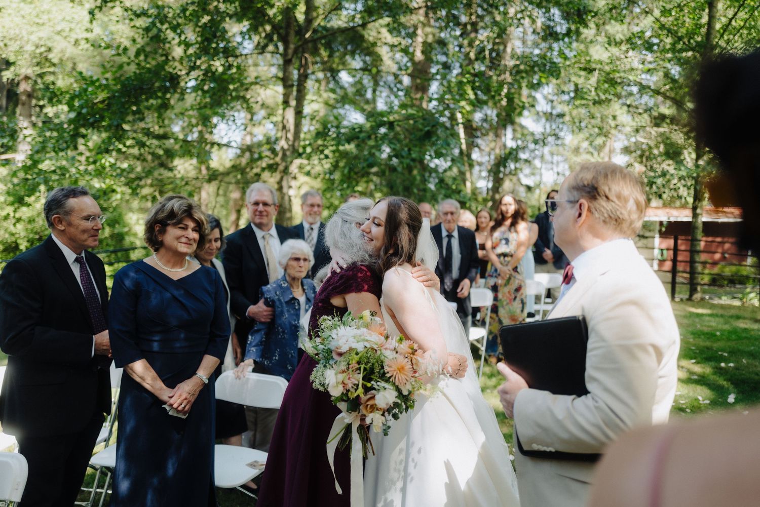 A joyful wedding ceremony moment with guests celebrating in a garden setting.