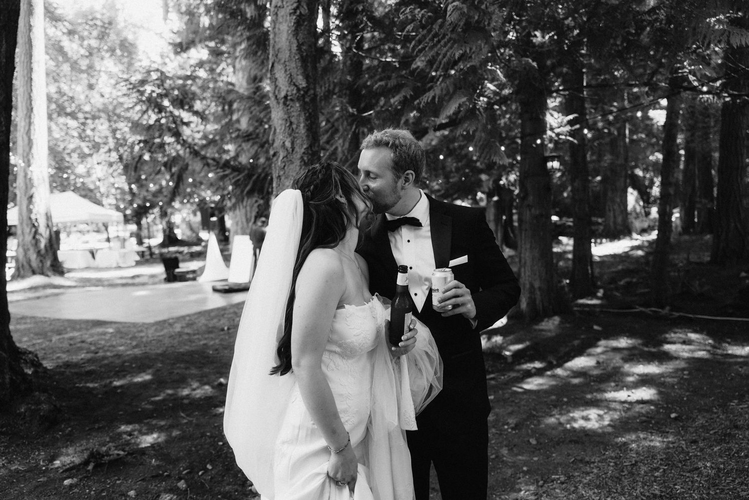 Black and white wedding photos showing couples and wedding party members in a wooded outdoor setting.