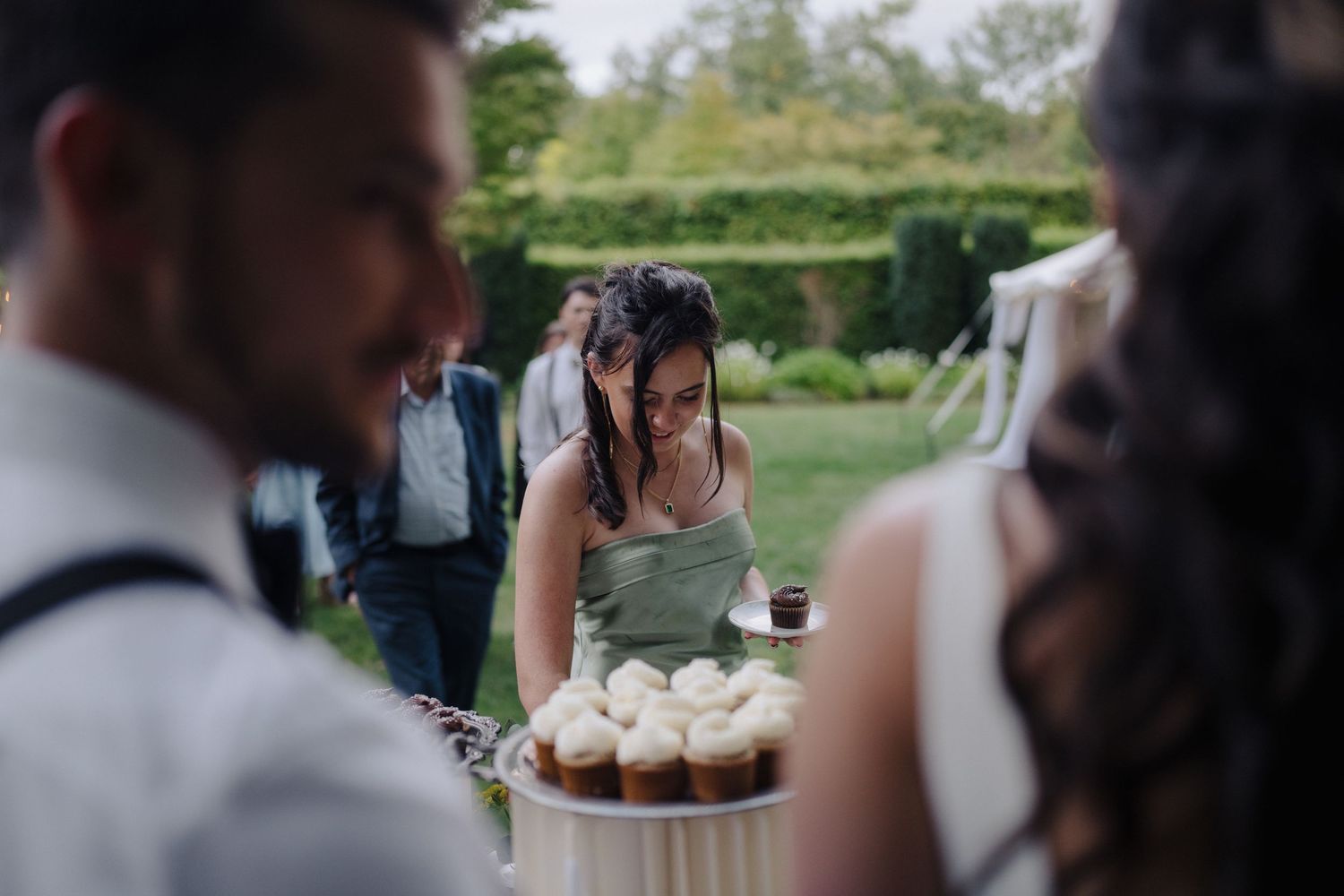 Wedding reception guests mingle and celebrate at outdoor tables.