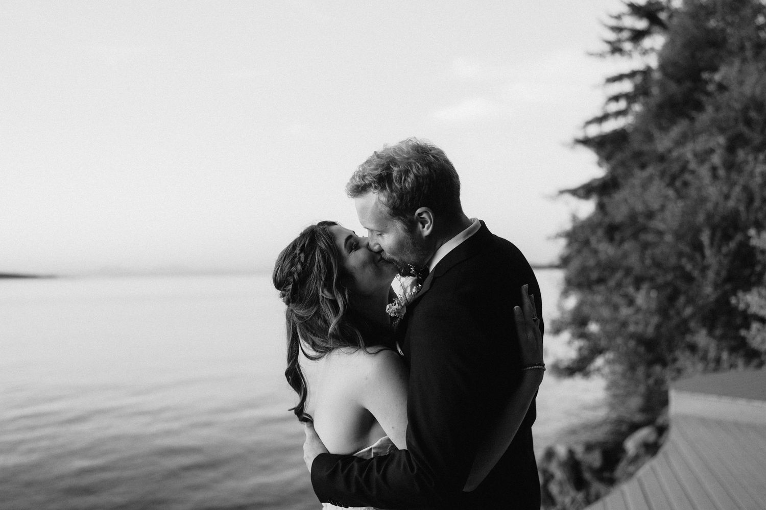 Black and white photos capture intimate moments of a wedding couple against a coastal backdrop.