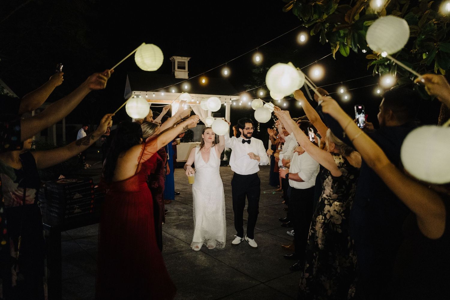 Wedding celebration at night with guests holding sparklers creating a magical atmosphere.