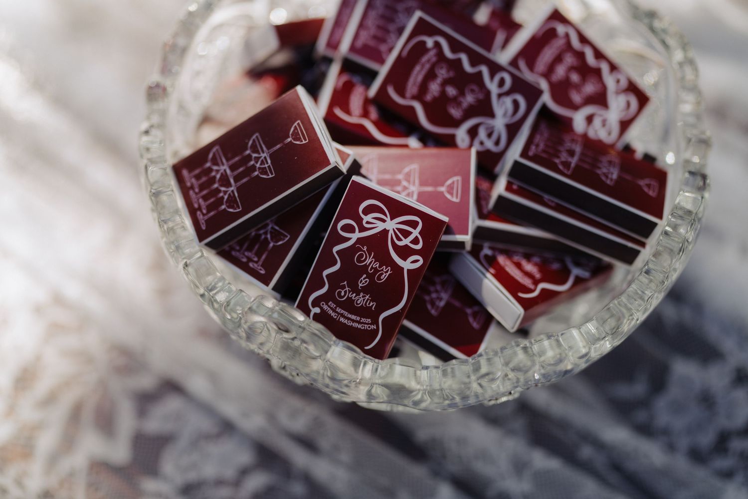 Red and white wedding invitation cards arranged on a decorative glass plate.